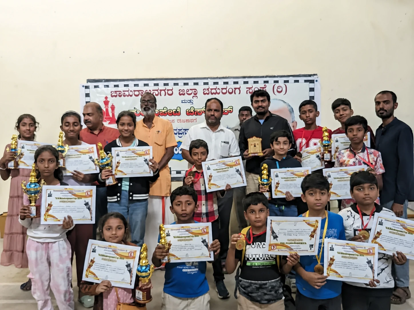 Chess students with certificates and trophies during the academy coaching journey