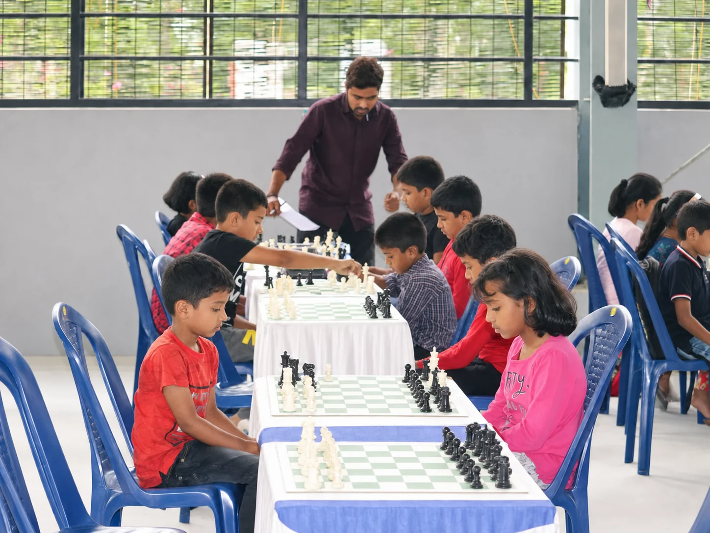 Students learning chess together in an offline class