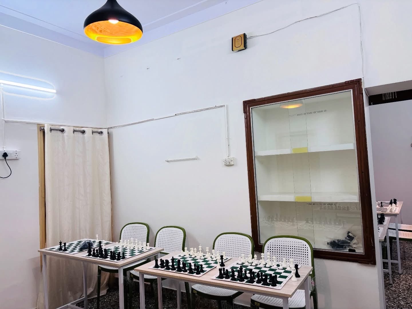 Dedicated chess learning space with boards and seating