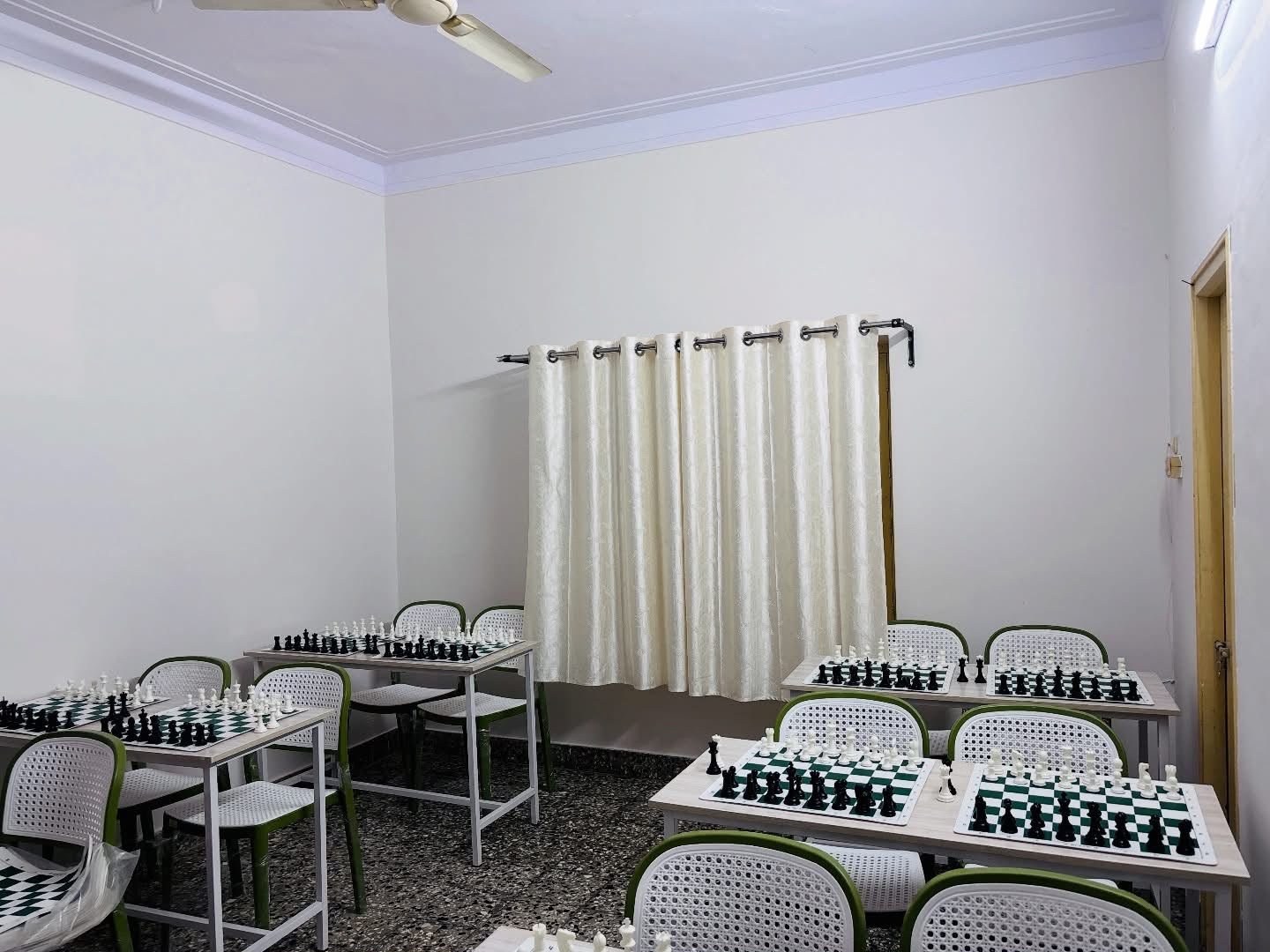 Spacious academy room with multiple chess training stations