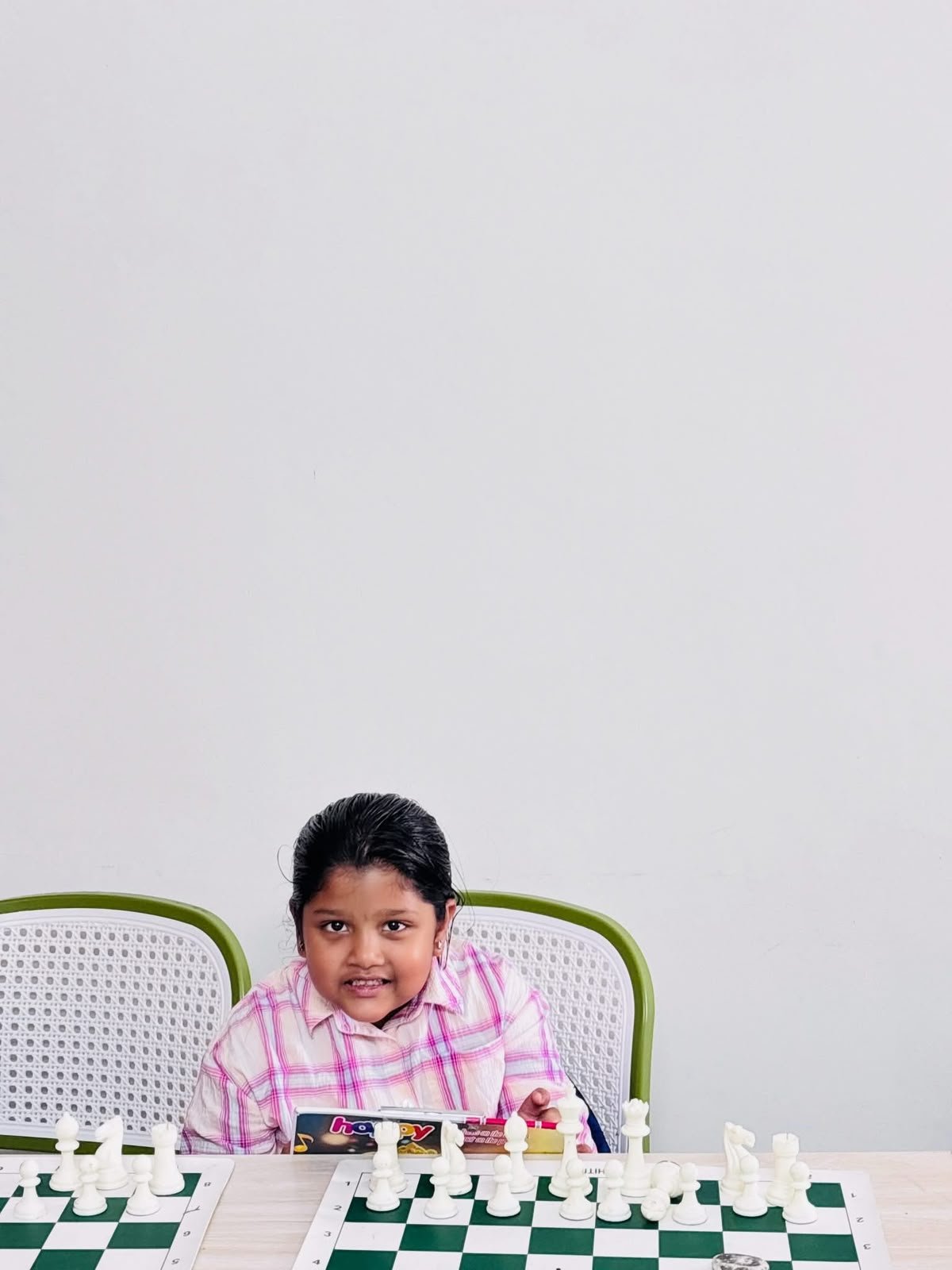 Young student seated at a chessboard in the academy