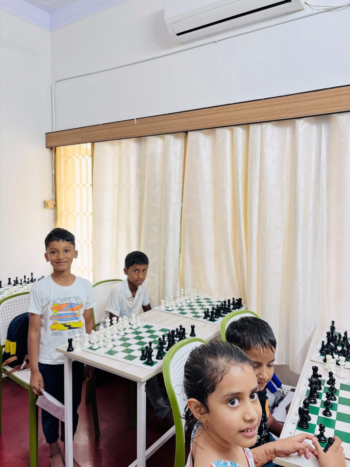 Children learning chess together in the academy classroom
